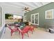 Relaxing screened-in porch with ceiling fan, outdoor furniture, and access to the backyard at 3123 Westbrook Trce, Lawrenceville, GA 30044