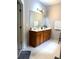 Bright bathroom featuring a double sink vanity with a large mirror and wood cabinets at 3439 Tupelo Trail, Auburn, GA 30011