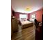 Pink bedroom featuring a bed, a mirror and wood laminate flooring at 3439 Tupelo Trail, Auburn, GA 30011