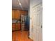 Kitchen featuring hardwood floors, wood cabinets, stainless appliances, and granite countertops with access to a pantry at 3439 Tupelo Trail, Auburn, GA 30011
