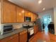 Kitchen featuring hardwood floors, wood cabinets, stainless appliances, and granite countertops at 3439 Tupelo Trail, Auburn, GA 30011