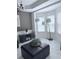 Bright living room with large windows and a modern floor lamp illuminating the space at 3439 Tupelo Trail, Auburn, GA 30011