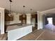 Modern kitchen with an island, pendant lighting, and stainless steel appliances at 5444 Miravista Way, Hoschton, GA 30548