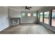 Spacious living room with a fireplace and multiple windows at 5444 Miravista Way, Hoschton, GA 30548