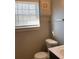 Bathroom featuring a toilet, vanity with sink, and window for natural light at 2367 Cascade Rd # B7, Atlanta, GA 30311