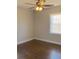 This bedroom features gleaming hardwood floors, a modern ceiling fan, and a bright window at 2367 Cascade Rd # B7, Atlanta, GA 30311