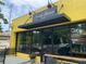 Exterior of Natalie Bianca est 2024 shop on a yellow brick building with a black awning at 2367 Cascade Rd # B7, Atlanta, GA 30311
