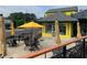 Outdoor seating area with yellow umbrellas and a view of Powered Plants building at 2367 Cascade Rd # B7, Atlanta, GA 30311