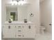 Elegant bathroom featuring a dual sink vanity with quartz countertops and black fixtures at 4252 Keheley Lake Dr, Marietta, GA 30066
