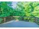 Wooden deck overlooking a lush green yard with mature trees at 4252 Keheley Lake Dr, Marietta, GA 30066