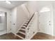 Inviting foyer featuring hardwood floors, staircase, and a bright white front door at 4252 Keheley Lake Dr, Marietta, GA 30066