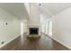 Open-concept living room featuring a stone fireplace, hardwood floors, and backyard access at 4252 Keheley Lake Dr, Marietta, GA 30066