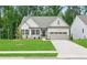 Charming single-Gathering home featuring a well-manicured lawn, stone accents, and a two-car garage at 55 Black Rock Rdg, Sharpsburg, GA 30277