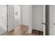 Hallway with laminate flooring leading to a closet and bedroom at 55 Black Rock Rdg, Sharpsburg, GA 30277