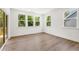 Bright living room with wood floors, many windows, and sliding glass door to the outside at 55 Black Rock Rdg, Sharpsburg, GA 30277