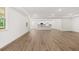 Bright, open-concept living room with wood floors and a view into the kitchen at 55 Black Rock Rdg, Sharpsburg, GA 30277