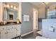 Well-lit bathroom with a modern vanity, fixtures, and tiled walk-in shower at 3314 Eagle Watch Dr, Woodstock, GA 30189