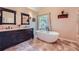 Charming bathroom featuring an elegant vanity, soaking tub, and stylish finishes at 3314 Eagle Watch Dr, Woodstock, GA 30189