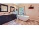 This full bathroom has a modern tub, vanity, and black matte fixtures at 3314 Eagle Watch Dr, Woodstock, GA 30189