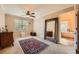Neutral bedroom with a large window and vintage mirror reflecting ensuite bathroom at 3314 Eagle Watch Dr, Woodstock, GA 30189