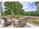 Outdoor deck with lots of seating and wooded views at 3314 Eagle Watch Dr, Woodstock, GA 30189