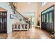 Spacious foyer showcasing hardwood floors, staircase, and stylish decor at 3314 Eagle Watch Dr, Woodstock, GA 30189