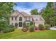 Stately traditional home featuring a well-manicured lawn and mature trees at 3314 Eagle Watch Dr, Woodstock, GA 30189