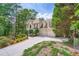 Charming exterior view of home with landscaped front yard and spacious driveway leading to a two-car garage at 3314 Eagle Watch Dr, Woodstock, GA 30189