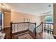 Open hallway with chandelier, staircase, hardwood flooring, and arched window at 3314 Eagle Watch Dr, Woodstock, GA 30189