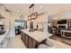 Spacious kitchen with center island, granite countertops, pendant lights, tile flooring, and stainless appliances at 3314 Eagle Watch Dr, Woodstock, GA 30189