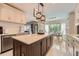 Bright eat-in kitchen featuring an island, tile backsplash, stainless steel appliances, and pendant lighting at 3314 Eagle Watch Dr, Woodstock, GA 30189