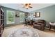 Home office space with built in shelving, natural light, and comfortable furniture at 3314 Eagle Watch Dr, Woodstock, GA 30189