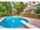 Outdoor pool and diving board with a view of the house and a wooded backdrop at 3314 Eagle Watch Dr, Woodstock, GA 30189