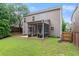 View of the backyard with a screened porch, concrete patio, and green lawn at 5901 Cobblestone Creek Cir, Mableton, GA 30126