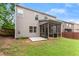 View of the backyard with a screened porch and a concrete patio at 5901 Cobblestone Creek Cir, Mableton, GA 30126