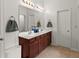 Bathroom featuring double sinks with vanity, a large mirror, and modern fixtures at 5901 Cobblestone Creek Cir, Mableton, GA 30126