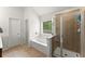 Bright bathroom with separate shower and soaking tub; the perfect retreat at 5901 Cobblestone Creek Cir, Mableton, GA 30126