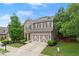 Charming two-story home with a well-manicured lawn, a two-car garage, and lovely landscaping, with gray paint and stone accents at 5901 Cobblestone Creek Cir, Mableton, GA 30126