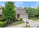 Charming two-story home with a well-manicured lawn, a two-car garage, and lovely landscaping, with gray paint and stone accents at 5901 Cobblestone Creek Cir, Mableton, GA 30126