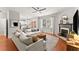 Inviting living room with fireplace, hardwood floors, neutral color palette, and lots of natural light at 5901 Cobblestone Creek Cir, Mableton, GA 30126