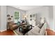 Cozy living room featuring comfortable seating, hardwood floors, and natural light from the window at 5901 Cobblestone Creek Cir, Mableton, GA 30126