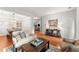 Bright living room with hardwood floors, stylish sofa, and console table at 5901 Cobblestone Creek Cir, Mableton, GA 30126