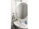 Elegant powder room featuring a pedestal sink, oval mirror, and fresh decor at 5901 Cobblestone Creek Cir, Mableton, GA 30126