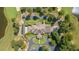 Overhead perspective of a home surrounded by golf course, with a circular driveway and mature trees at 9634 Coastal Pointe Dr, Villa Rica, GA 30180