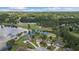 Stunning aerial view of lakeside homes on a golf course community with lush green trees and blue skies at 9634 Coastal Pointe Dr, Villa Rica, GA 30180