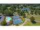 Aerial view of the community featuring a sparkling pool and tennis courts near the lake and golf course at 9634 Coastal Pointe Dr, Villa Rica, GA 30180