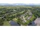 Panoramic aerial shot of a neighborhood on a golf course by a lake surrounded by mature trees at 9634 Coastal Pointe Dr, Villa Rica, GA 30180