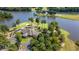 Captivating aerial shot of a lakefront home, showcasing a golf course and meticulously maintained grounds at 9634 Coastal Pointe Dr, Villa Rica, GA 30180