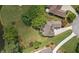 Overhead view of a landscaped home with a circular driveway and lush green lawn near the golf course at 9634 Coastal Pointe Dr, Villa Rica, GA 30180