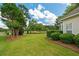 Manicured backyard with lush green lawn and views of the golf course at 9634 Coastal Pointe Dr, Villa Rica, GA 30180